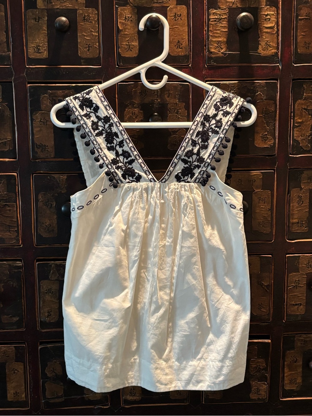 J. Crew black and sleeveless top with Pom Pom detail
